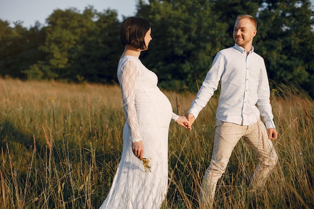 Cute family spending time in a summer field