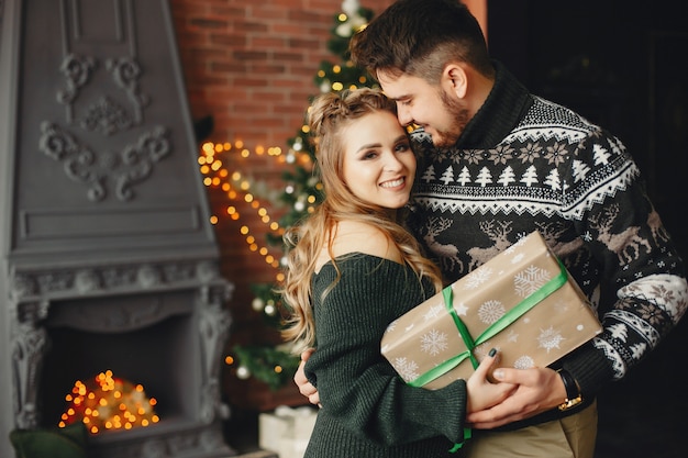 Cute family standing near Christmas tree