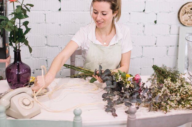 Cute florist arranging bouquet