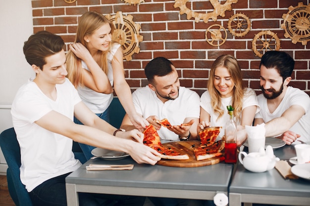 Cute friends in a cafe eatting a pizza