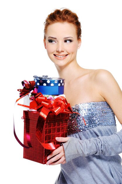 Cute fun femlae holding the christmas present boxes - isolated on white