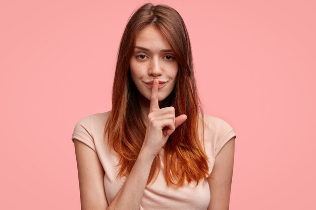 Cute ginger woman with pink T-shirt