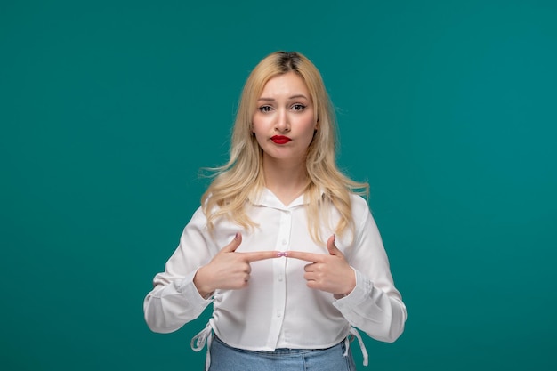 Cute girl blonde young pretty girl in a white shirt holding fingers together confused