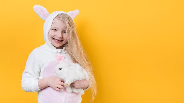 Cute girl in bunny ears with rabbit 