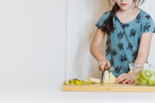 Cute girl cutting pears