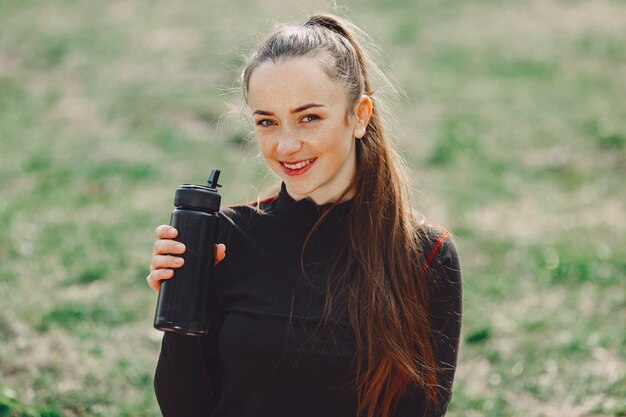 Cute girl doing yoga in a summer park