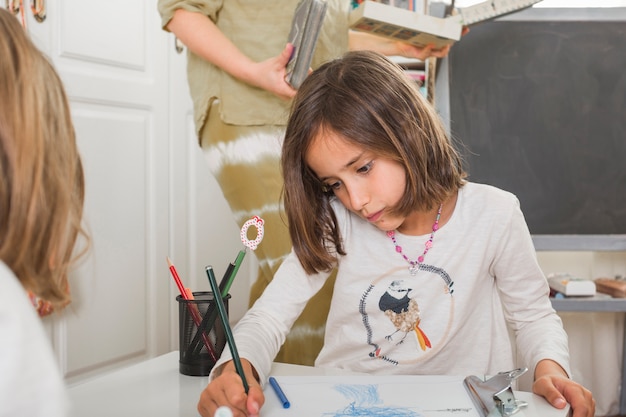 Cute girl drawing at home