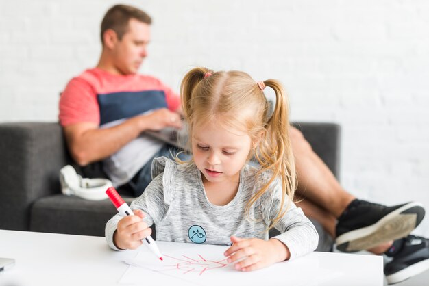 Cute girl drawing sketch with marker at home