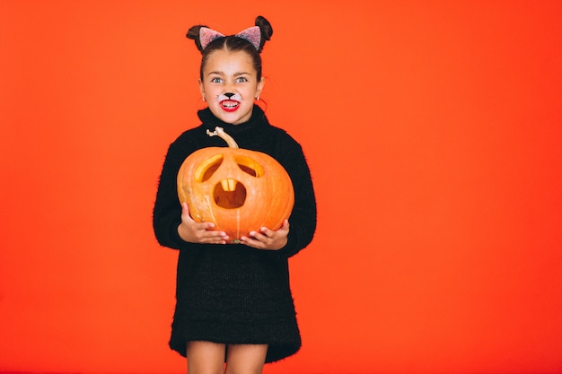 Cute girl dressed in halloween costume in studio