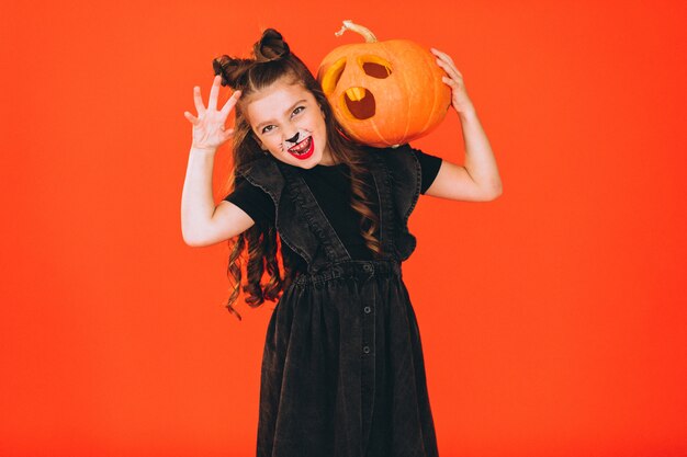 Cute girl dressed in halloween costume in studio