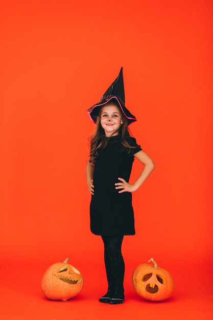 Cute girl dressed in halloween costume in studio