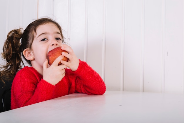 Free photo cute girl eating apple