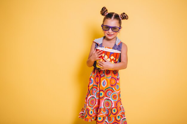 Cute girl eating popcorn