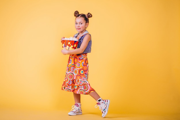 Cute girl eating popcorn