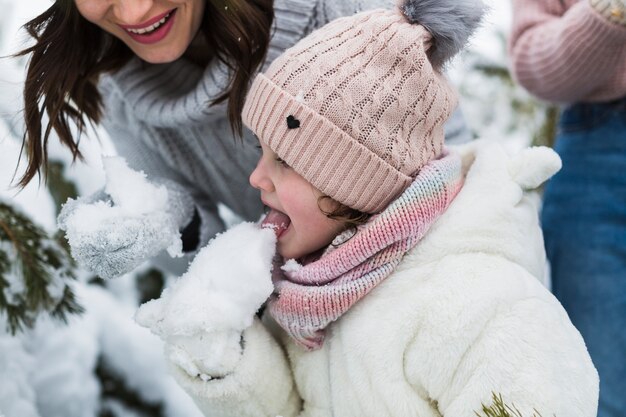 Cute girl eating snow