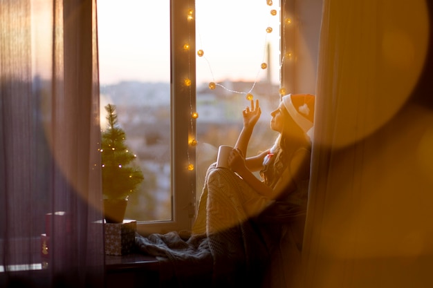 Cute girl feeling cozy with her mug on christmas