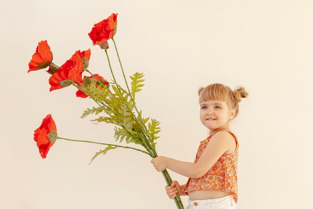Cute girl holding big flowers