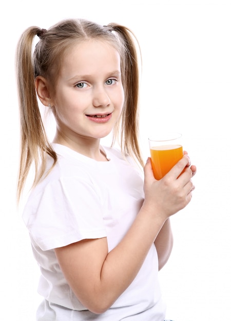 Cute girl holding glass of fresh orange juice