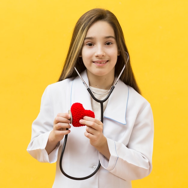 Cute girl listening to heart front view