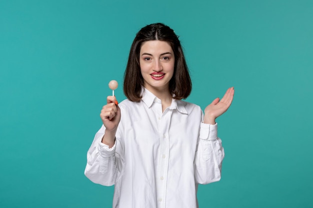 Free photo cute girl lovely young pretty brunette girl in white shirt giving a white candy