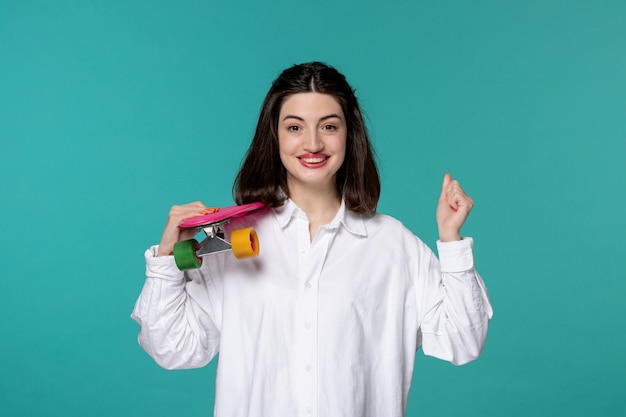 Cute girl lovely young pretty brunette girl in white shirt holding fists up