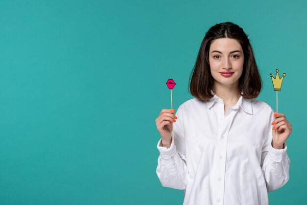 Cute girl lovely young pretty brunette girl in white shirt holding paper requisites