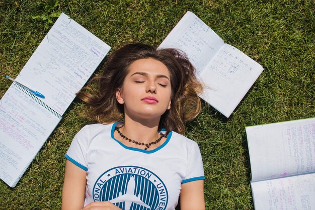 Cute girl lying on grass