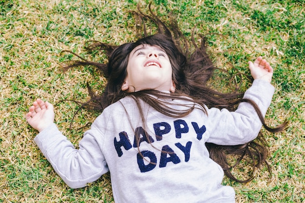 Free photo cute girl lying on grass