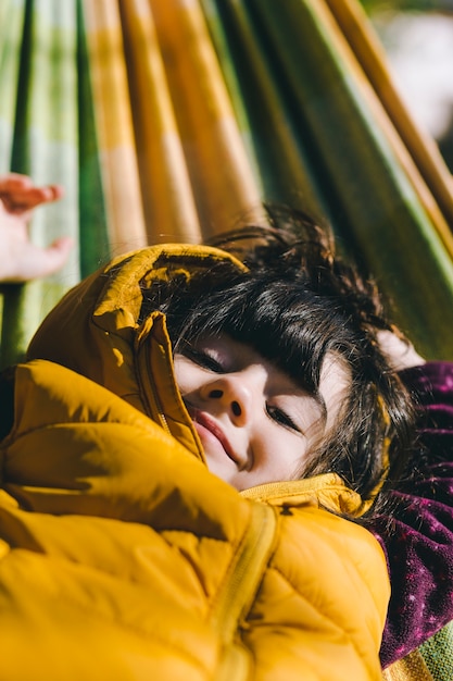 Cute girl lying on hammock