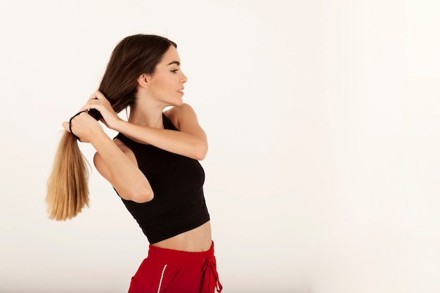 Cute girl making her ponytail