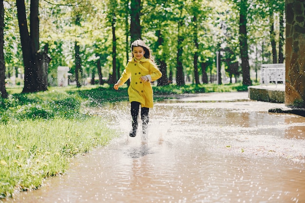 Free photo cute girl plaiyng on a rainy day