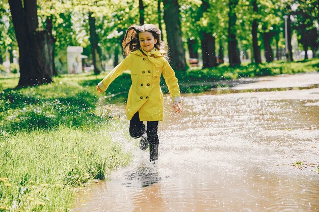 Cute girl plaiyng on a rainy day