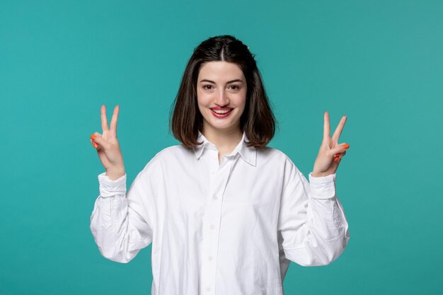 Cute girl pretty brunette young sweet girl in white shirt showing peace sign