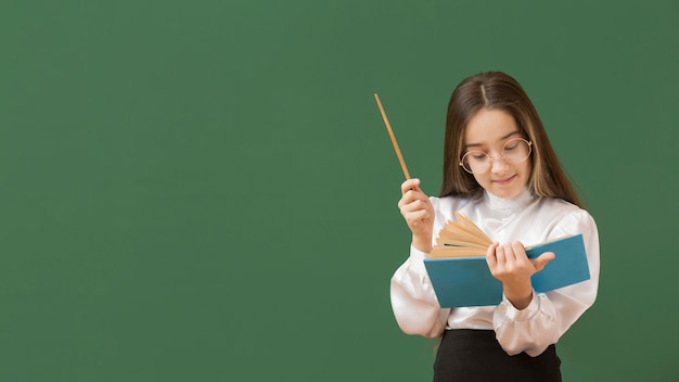 Cute girl reading book copy space