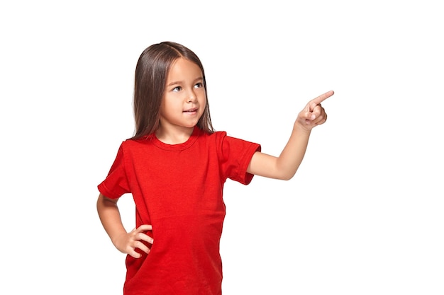 Cute girl in red t-shirt shows isolated on white background, red t-shirt