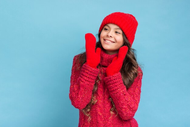 Cute girl in red winter clothes