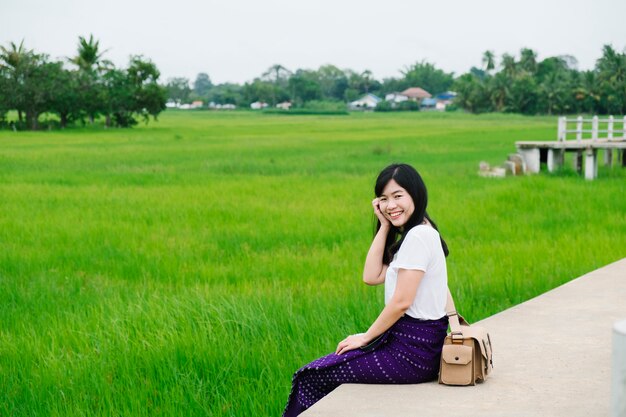 cute girl smile at rice field, Thailand