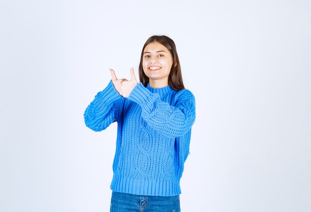 cute girl standing and giving thumbs up on white.