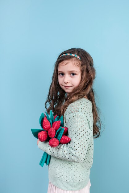 Cute girl standing with toy flowers