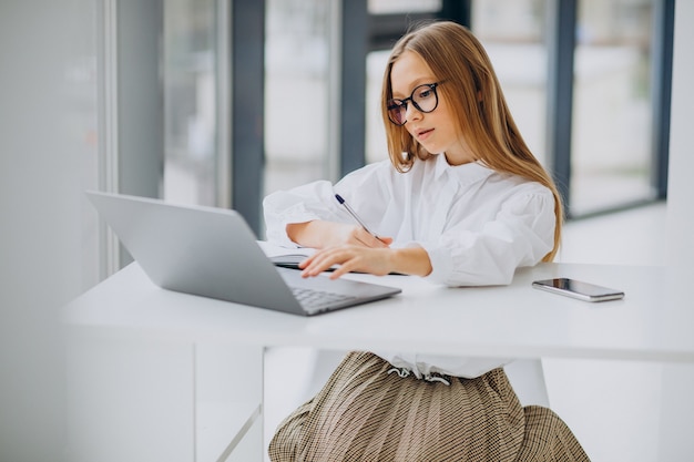 Cute girl studying on the computer at home