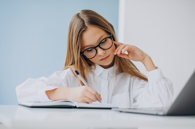 Cute girl studying on the computer at home