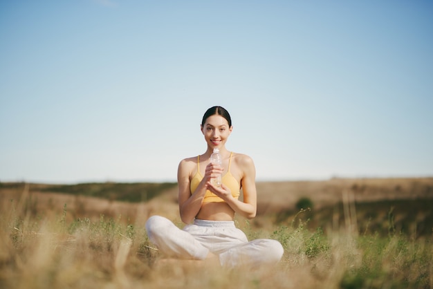 Free photo cute girl training on blue sky in a field