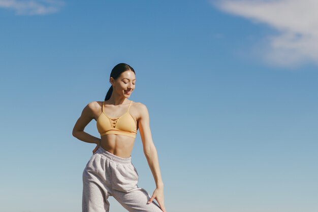 Cute girl training on blue sky