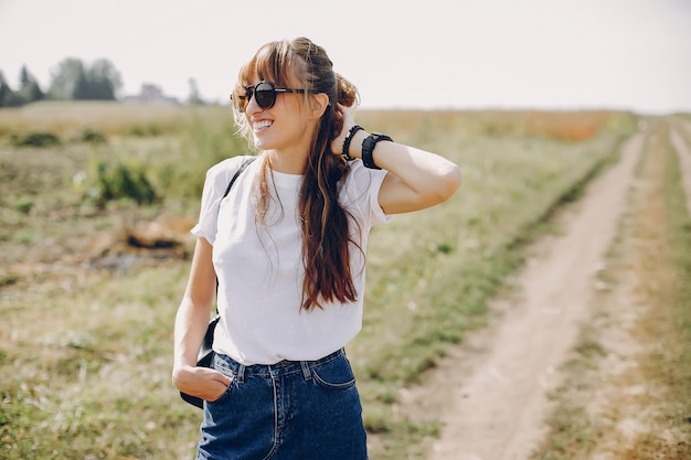 Free photo cute girl walking in a summer field