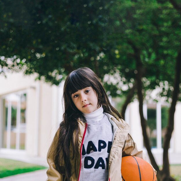 Cute girl with basketball ball
