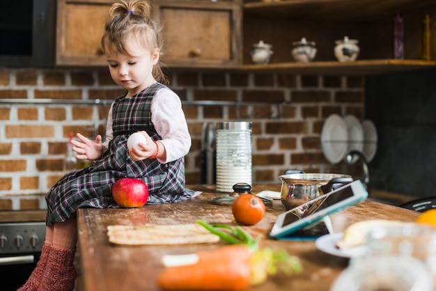 Cute girl with egg and apple