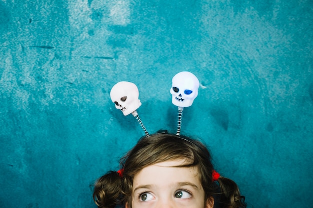 Free photo cute girl with halloween skulls