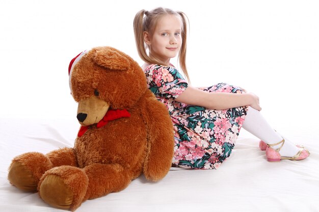 Cute girl with her teddy bear