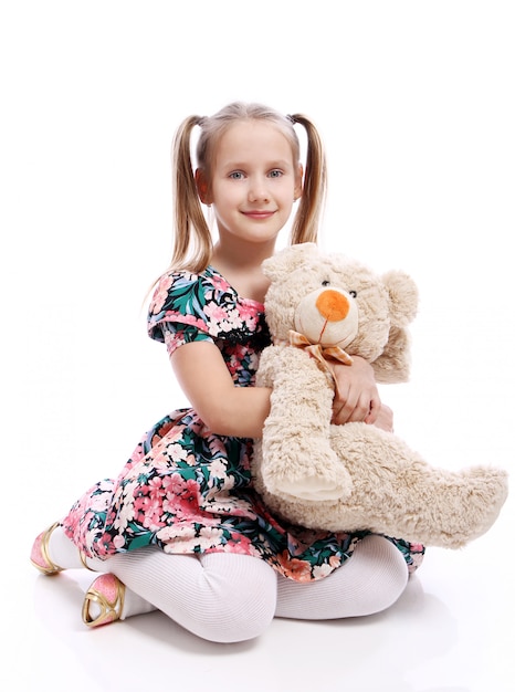 Cute girl with her teddy bear