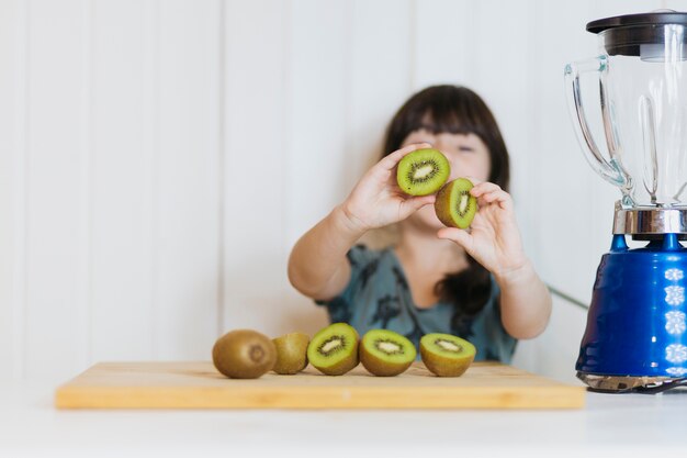 Cute girl with kiwifruits